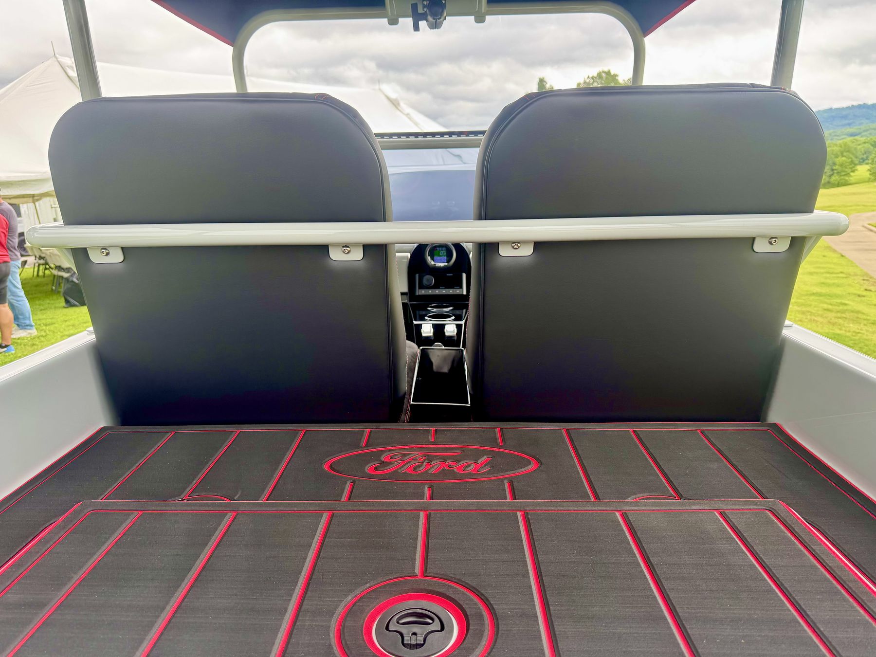 Rear deck with red trimmed tread mats and custom seat backs
