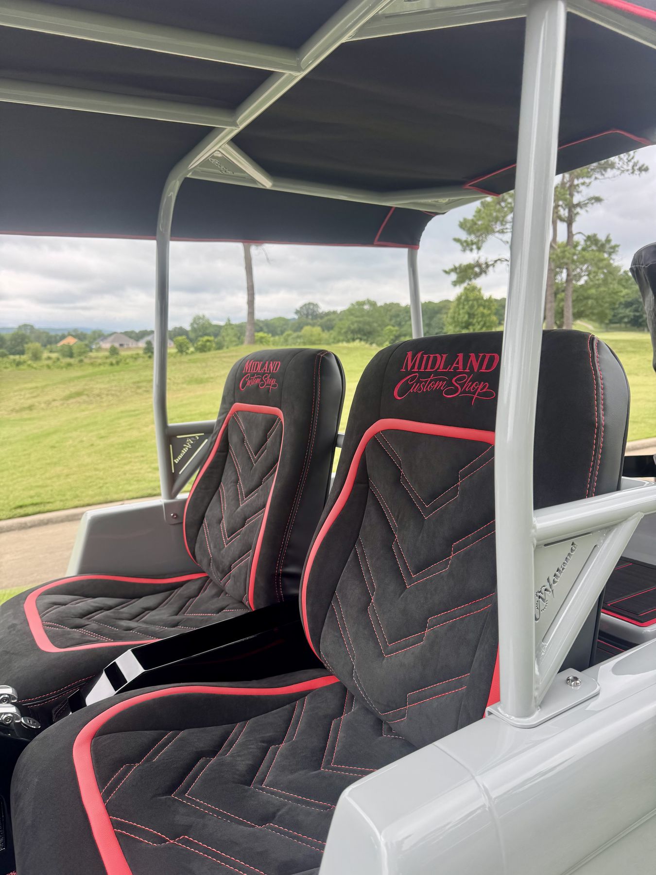 Custom red stitched seats with embroidered branding