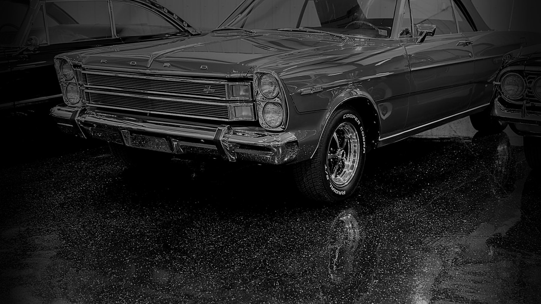Black and white Ford Galaxie convertible parked in the Midland Custom Shop showroom