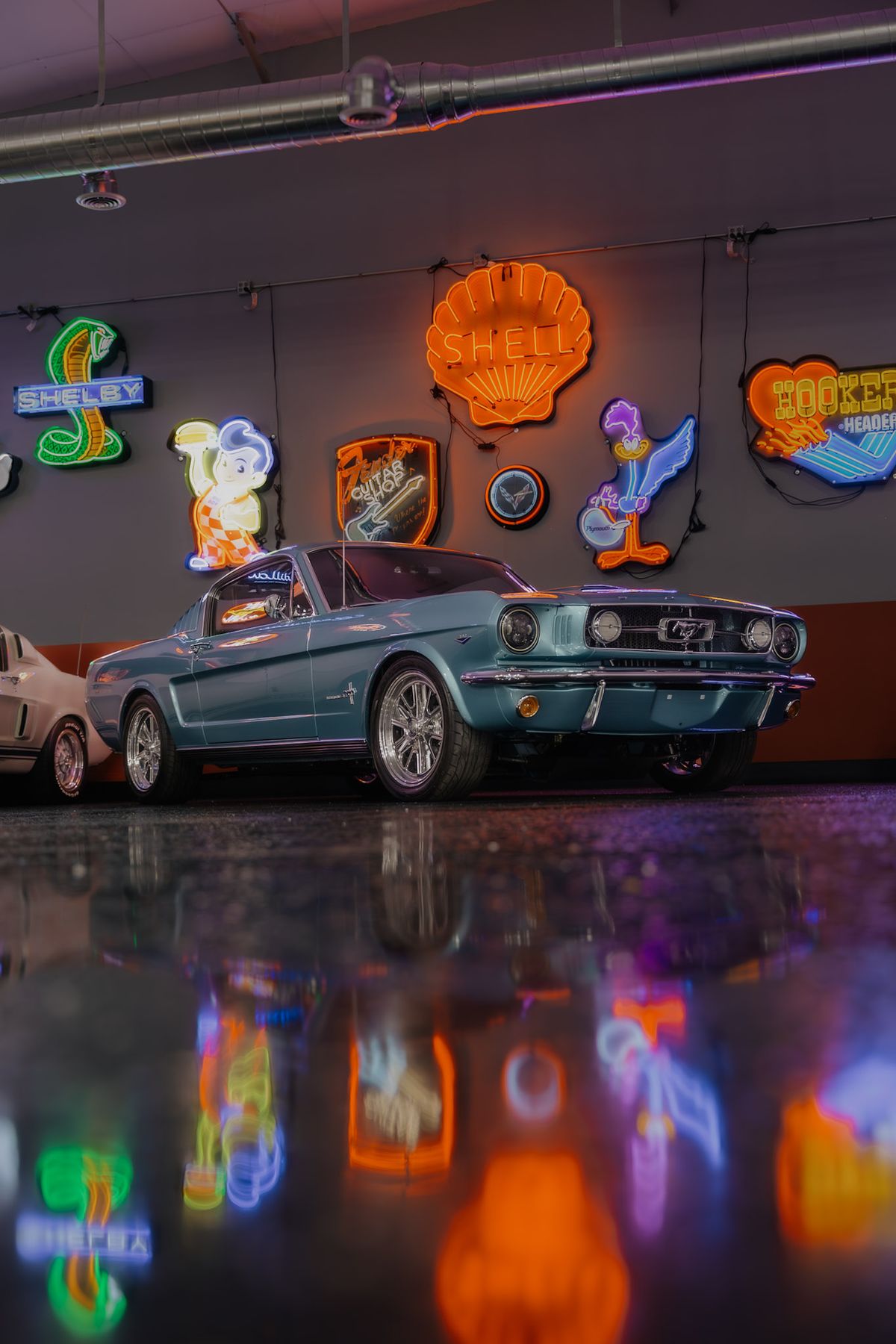 Classic teal Mustang fastback in the showroom