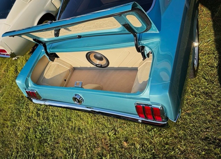 Custom fabricated Mustang trunk with cream paneling and built in speaker